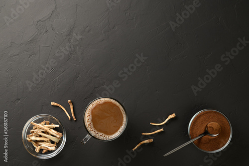 Alternative to coffee. Healthy drink chicory. Chicory coffee in a cup, roots and powder in bowls on a black background. Top view, copy space.