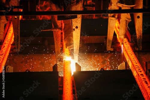 Steel billets at torch cutting in metallurgical plant. Metallurgical production, heavy industry, engineering, steelmaking.