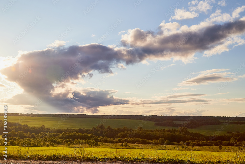 Beautiful landscape with blue sky, white clouds, sunset and field. Beautiful landscape with blue sky, white clouds, sunset and field.