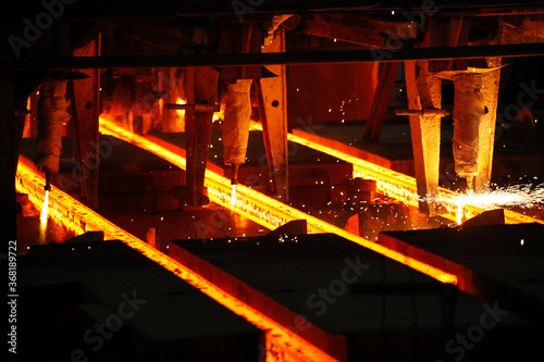 Steel billets at torch cutting in metallurgical plant. Metallurgical production, heavy industry, engineering, steelmaking.