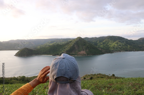 woman seeing bay on top of hill 