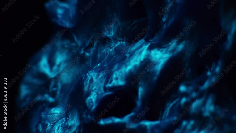 Abstract blue slime looking like texture rotating under blue light. Abstract blue slime looking like texture rotating under blue light.
