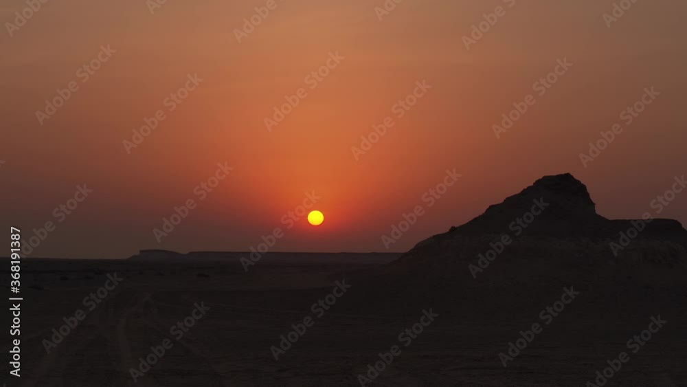 custom made wallpaper toronto digitalWide shot of a sunset with rocky hills in the foreground in Zekreet Desert in Qatar.