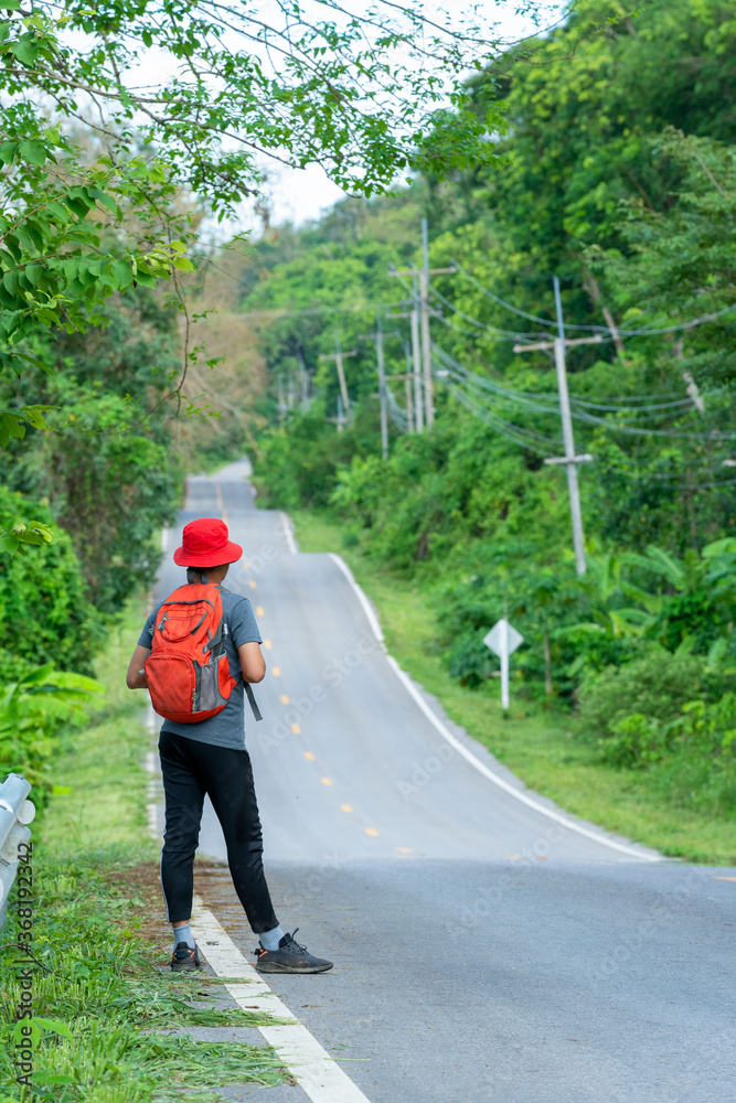 Long way to go,Tourist standing on the road.Travel concept.Challenge of journey. Long way to go,Tourist standing on the road.Travel concept.Challenge of journey.