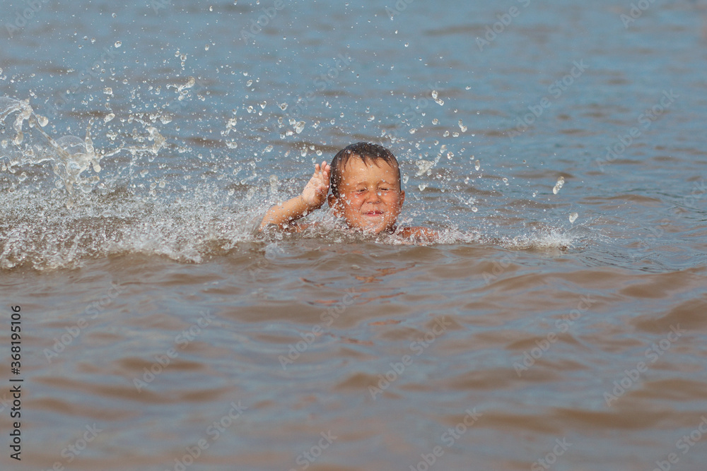 boy in the water with water splash 
