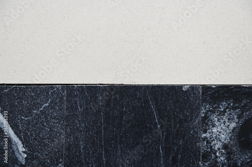 Poor-quality joint of light and dark ceramic floor tiles.Close-up of junction of black and white tiled surfaces.	