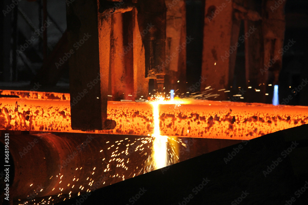 Steel billets at torch cutting in metallurgical plant. Metallurgical production, heavy industry, engineering, steelmaking. - obrazy, fototapety, plakaty 