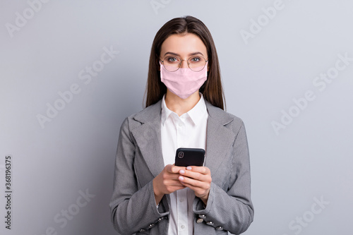 Close-up portrait of her she attractive businesslady wearing safety pink reusable mask using device gadget mers cov influenza remote distance discuss chatting isolated grey color background