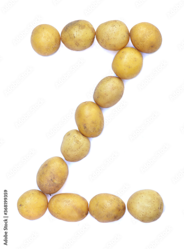 Letter Z of the English alphabet from potatoes. A letter made of fruit on a white background. Letter Z of the English alphabet from potatoes. A letter made of fruit on a white background.