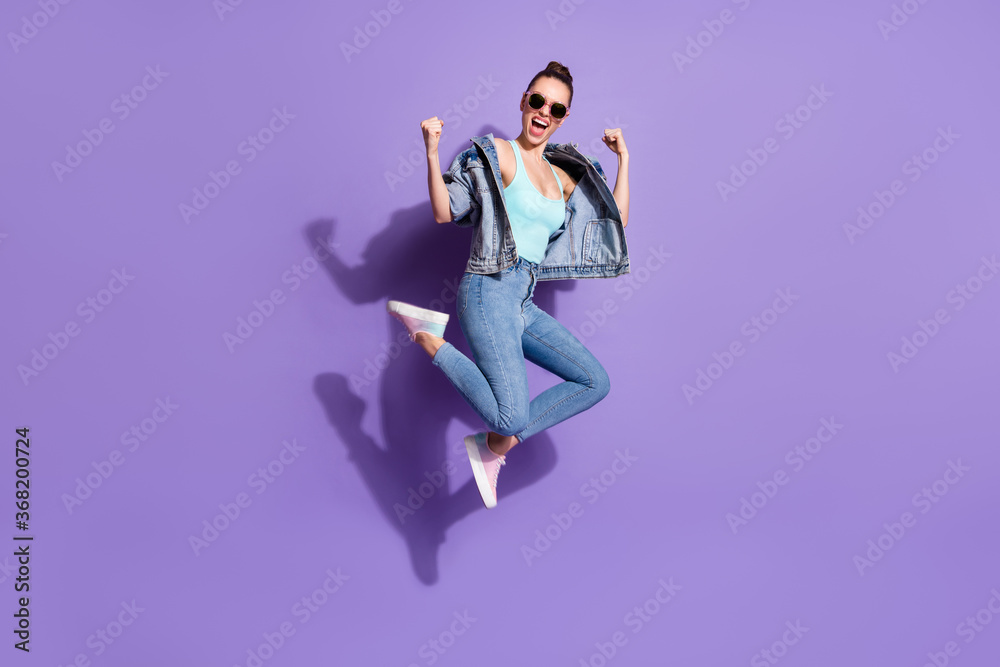 Full length body size view of nice attractive slim fit slender lucky ecstatic glad cheerful girl jumping rejoicing isolated on bright vivid shine vibrant lilac purple violet color background Full length body size view of nice attractive slim fit slender lucky ecstatic glad cheerful girl jumping rejoicing isolated on bright vivid shine vibrant lilac purple violet color background