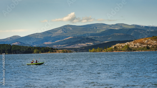 two young athletic men on their kayak canoeing and enjoying the tranquility of Aguilar dam