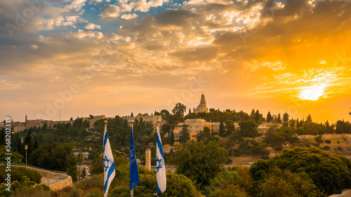 Beautiful sunrise over Mount Zion: Dormition Abbey, Jerusalem university college and greek ceminary; with the walls of Jerusalem's Old City, leading up to the Tower of David museum and the Jaffa Gate photo