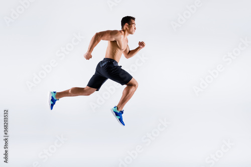 Full length body size view of his he nice attractive powerful professional sportive focused purposeful guy jumping running motivation isolated over light white pastel color background