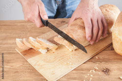 Caucasian man cutting bread. Healthy food