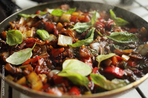 Healthy food vegetables are fried in a pan Tomato eggplant onion pepper zucchini