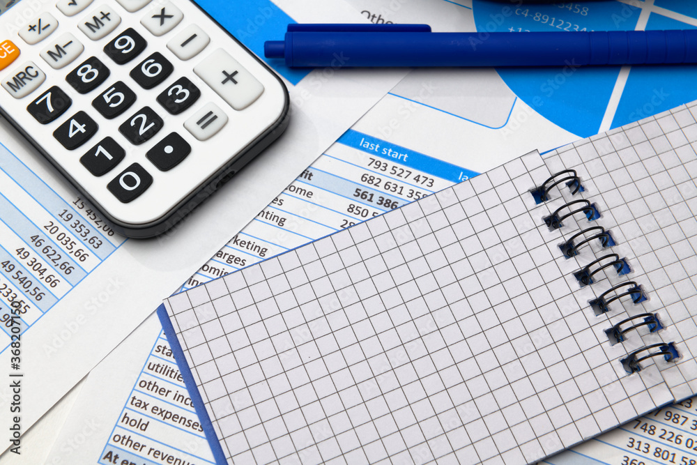business office desk closeup - financial reports, analysis and accounting, set of documents, tables and graphs, various items for bookkeeping, calculator business office desk closeup - financial reports, analysis and accounting, set of documents, tables and graphs, various items for bookkeeping, calculator