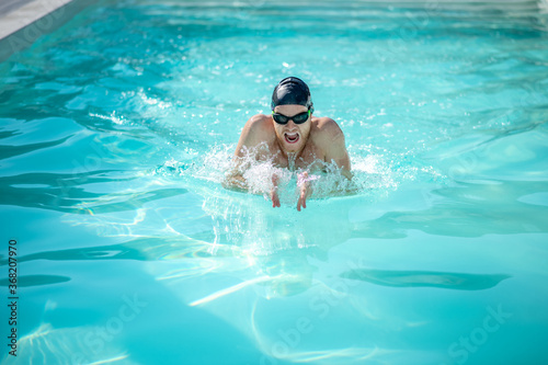 Swimmer with open mouth in water in pool