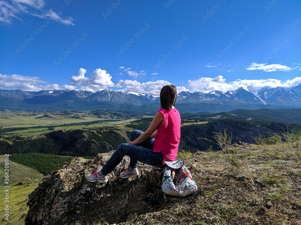 Woman traveler on the top of the mountain