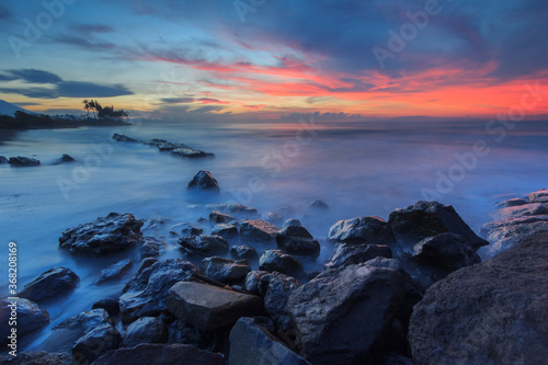sunrise on the rocky beach © Made