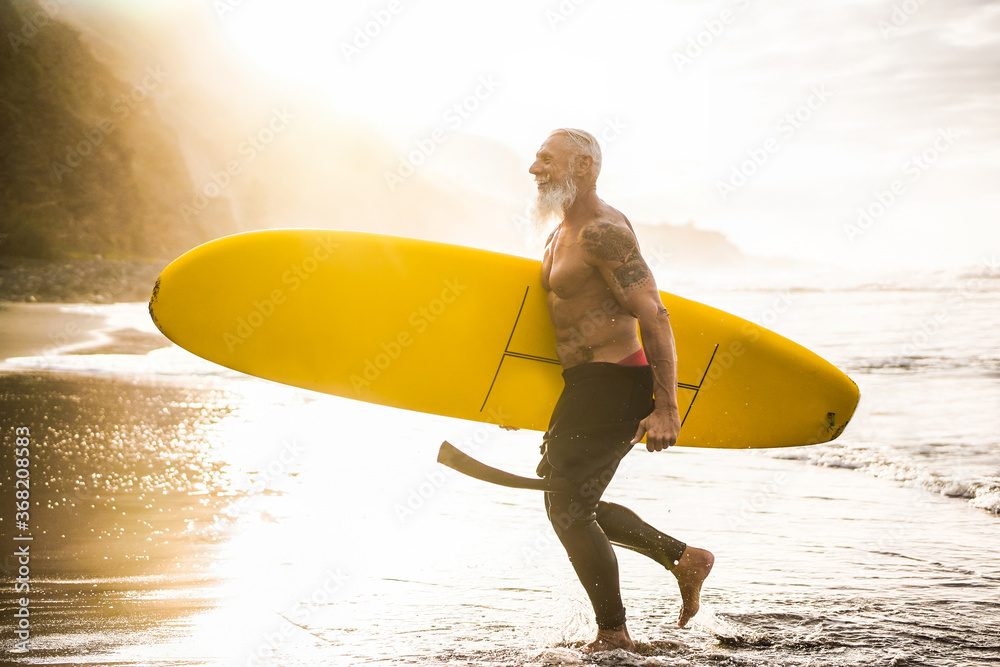 cube protein moustache Senior fit guy walking with longboard after surfing at sunset - Surfer  tattooed man having fun doing