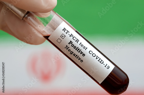 Stock photo of holding tube with Blood Test(novel Coronavirus 2019 disease,COVID-19,nCoV) and flag of Iran. Iran virus outbreak.