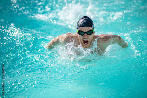 Male swimmer with open mouth arms underwater © zinkevych