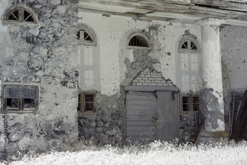 surreal landscape, old houses, infrared photo of the amazing nature of the snowy tree © ANDA