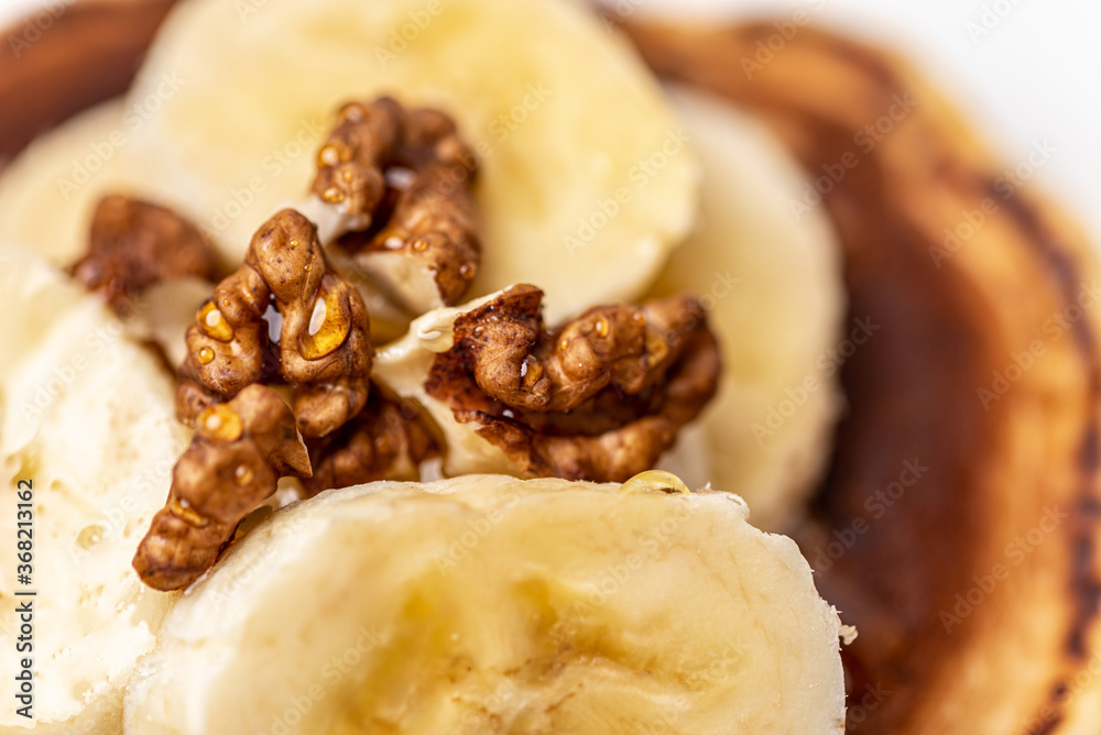 
Tasty breakfast. Pancake with banana, walnut and honey. Close-up.