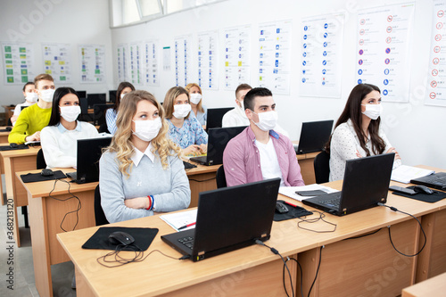 Group of students wearing protection masks in class