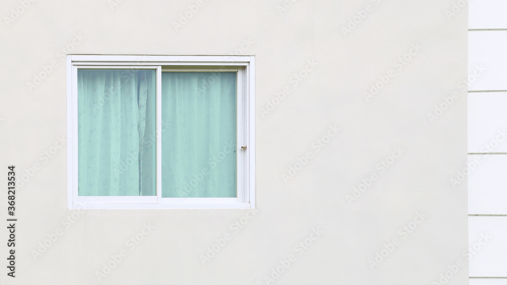 The white frame windows have blue curtains, with the windows on white concrete walls. With blank space to copy The white frame windows have blue curtains, with the windows on white concrete walls. With blank space to copy