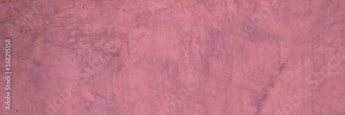 Texture of a old grungy pink concrete wall with cracks as a background or wallpaper