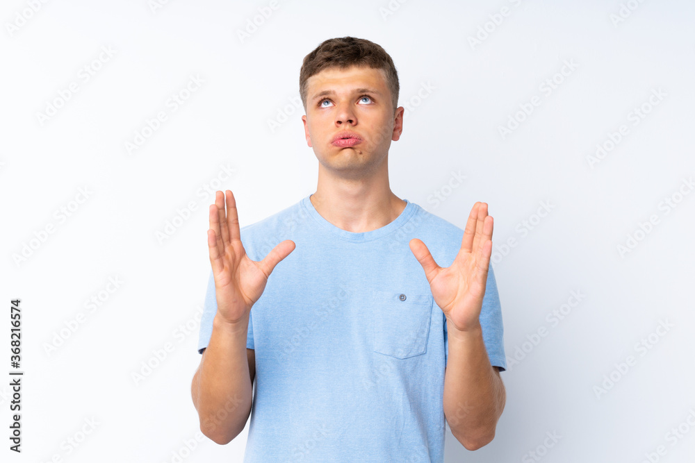 Young handsome man over isolated white background frustrated by a bad situation Young handsome man over isolated white background frustrated by a bad situation