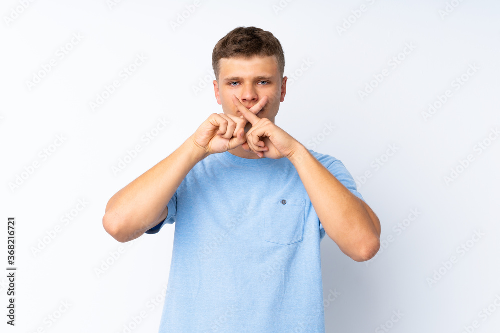 Young handsome man over isolated white background showing a sign of silence gesture