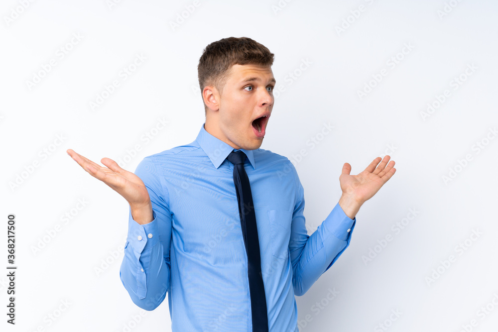 Young handsome businessman with surprise facial expression