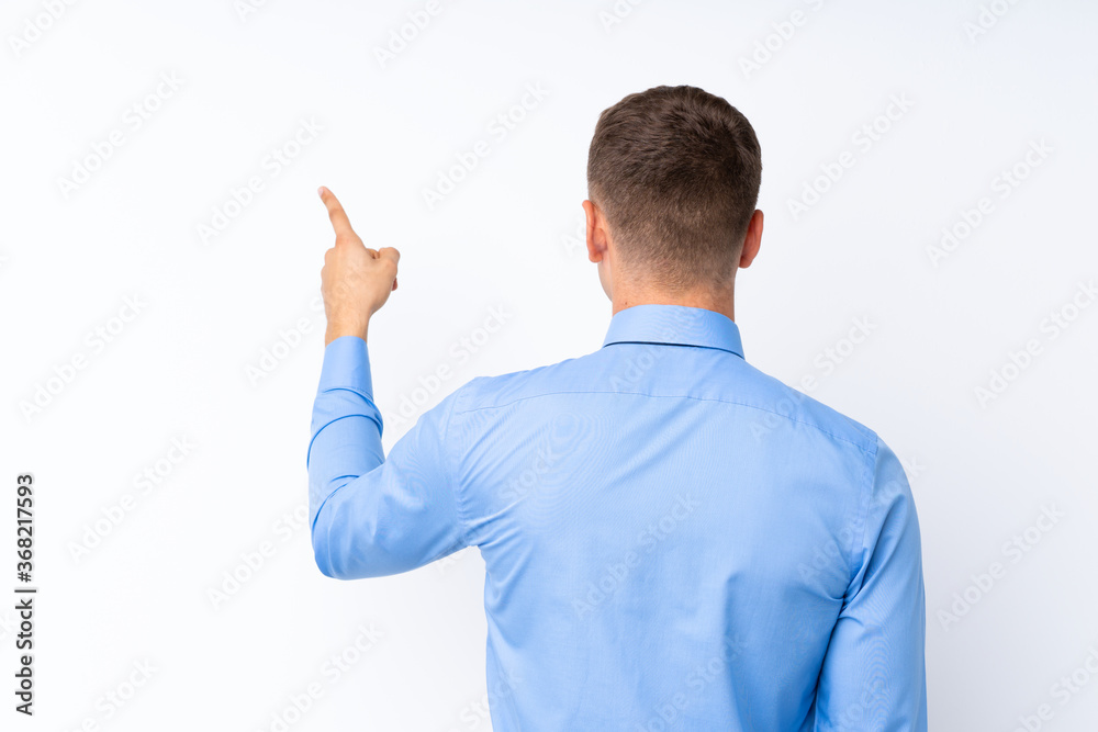 Young handsome businessman pointing back with the index finger Young handsome businessman pointing back with the index finger