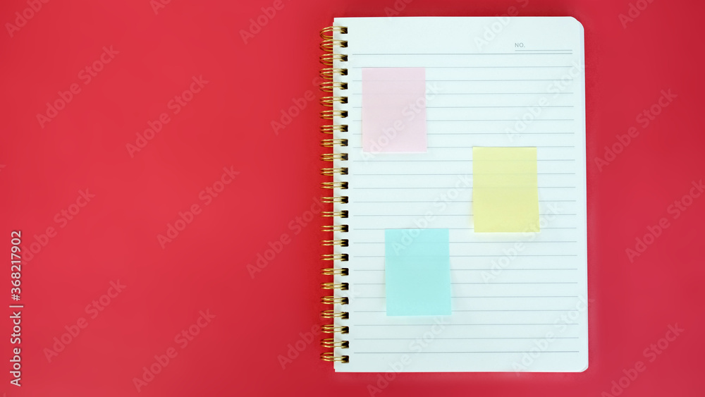 Open blank journal on red background. Concept for creative person planning. Back to school. Top view, flat lay, mockup Open blank journal on red background. Concept for creative person planning. Back to school. Top view, flat lay, mockup