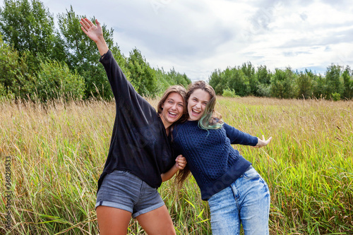 Summer holidays vacation happy people concept. Group of two girl friends dancing hugging and having fun together in nature outdoors. Lovely moments best friend. © Юлия Завалишина