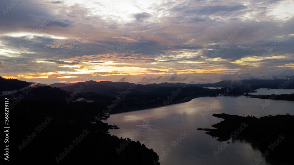 Obraz premium Aerial view of Kenyir Lake during blue hour sunrise.