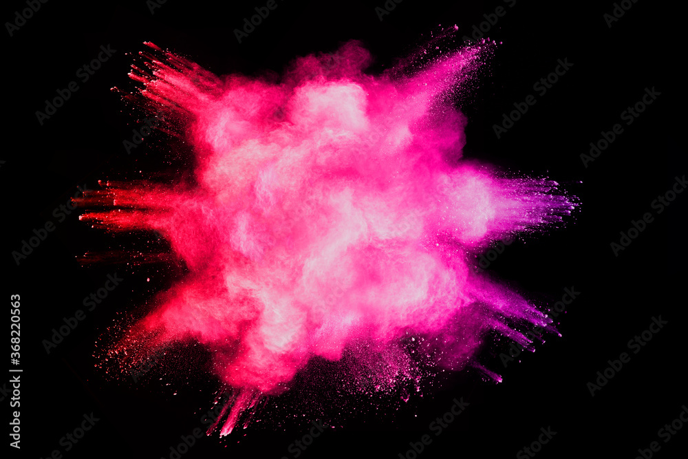 Red powder explosion on black background. Paint Holi.
