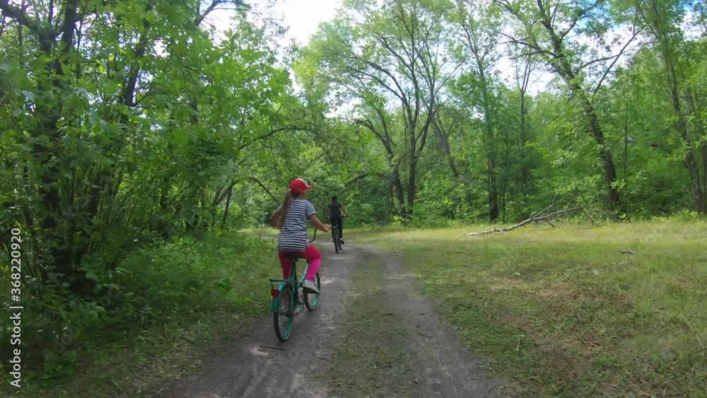 Young mother and daughter with bikes on forest. Young mother and daughter with bikes on forest.