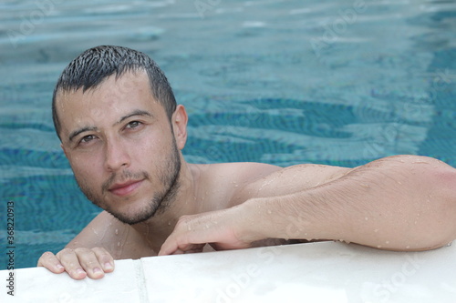 Handsome ethnic man smiling in swimming pool  © ajr_images