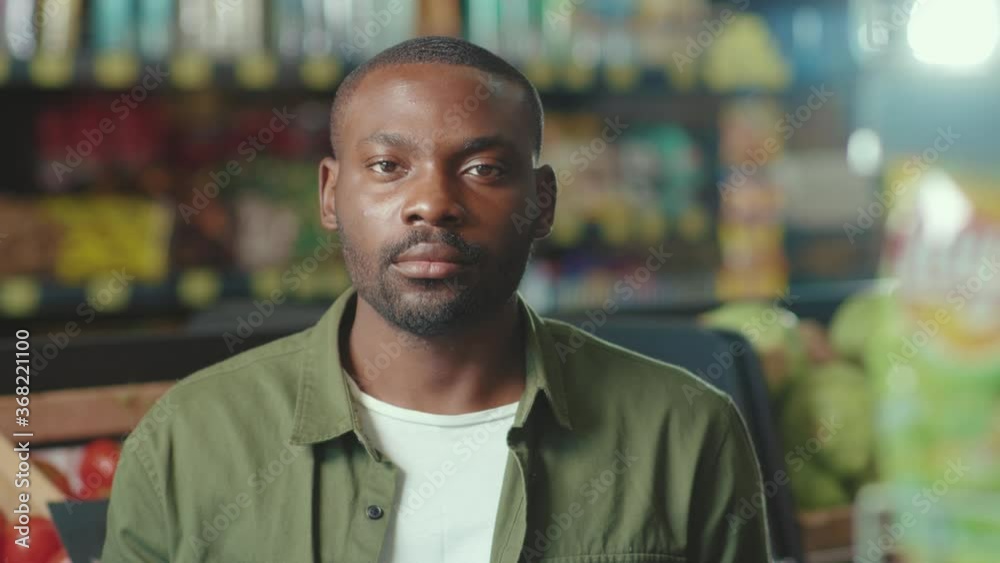 Portrait serious African american young man look at camera in the supermarket business ethnic food shopping black grocery market produce store supermarket healthy slow motion Portrait serious African american young man look at camera in the supermarket business ethnic food shopping black grocery market produce store supermarket healthy slow motion