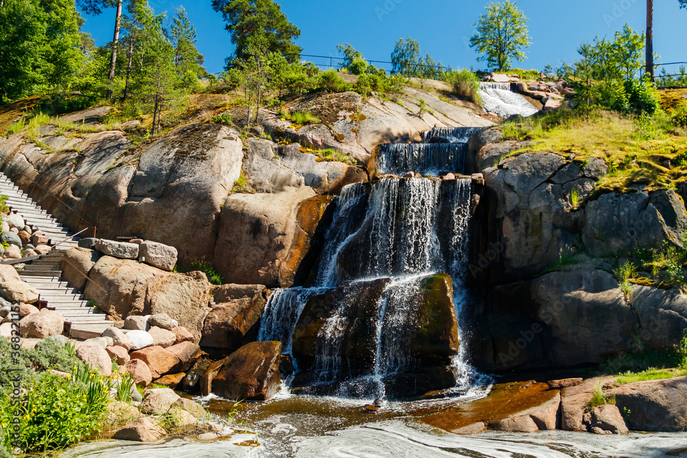 Waterfall cascading over rocks in Sapokka landscaping park Kotka, Finland.