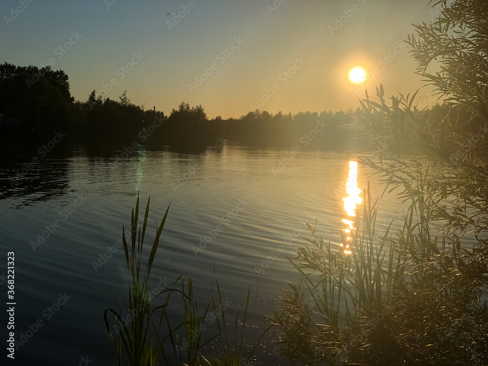 morning haze over a forest lake at dawn in summer morning haze over a forest lake at dawn in summer