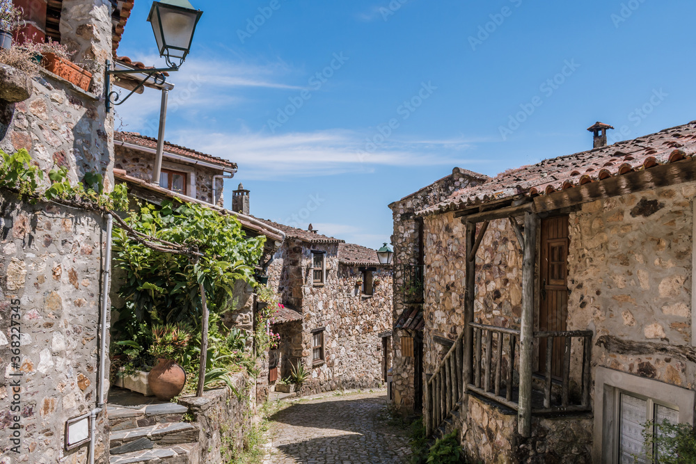 Famous schist village of Casal de São Simão, typical stone houses along narrow street, Portugal