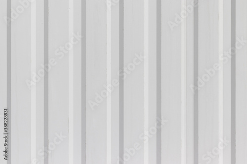 White metal wall or fence background with vertical corrugated stripes