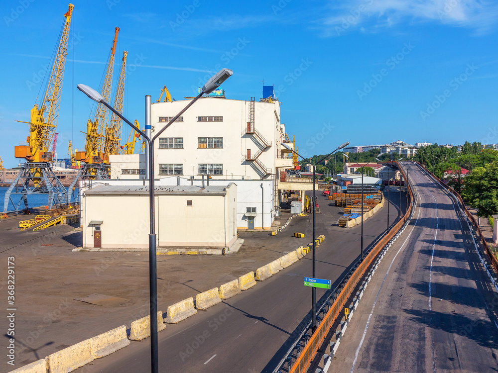 Odessa, Ukraine - July 6, 2016: Container cranes in cargo port terminal, cargo cranes without job in an empty harbor port. A crisis. Defaulted paralyzed entire economy of state, in the EU candidate