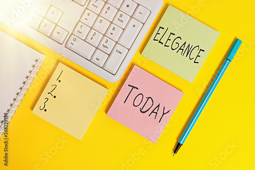 Conceptual hand writing showing Elegance. Concept meaning scientific precision, neatness, and simplicity of something Empty papers with copy space on yellow background table photo