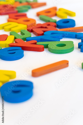 Colorful wooden alphabet on white background. Children toy for education.