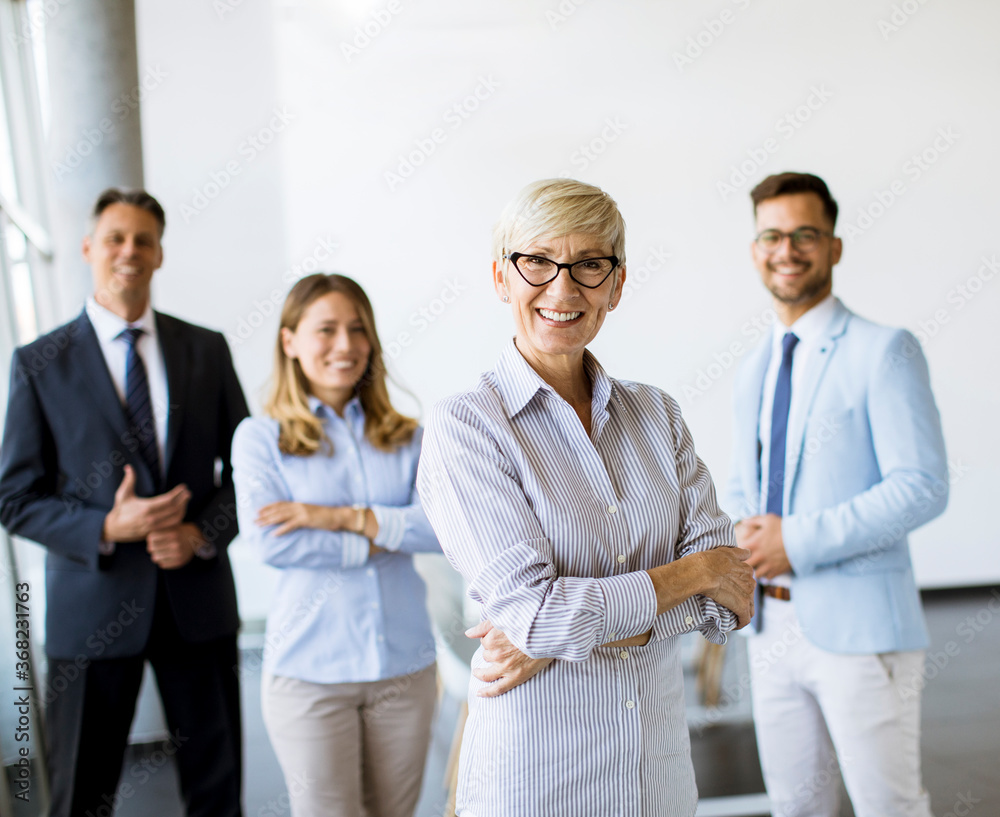 Group of a businesspeople standing together in the office Group of a businesspeople standing together in the office
